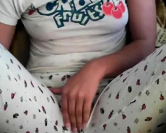 Amateur girl rubs her pussy through pajamas
