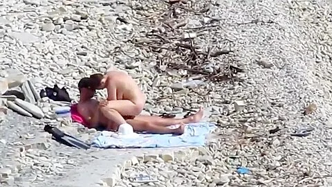 Couple fucked on a public beach while as people walked near