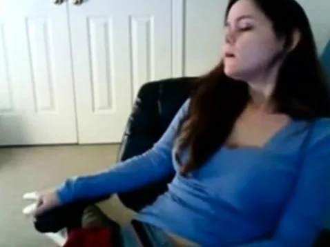 Babe has her hand down her sweat pants masturbating on cam