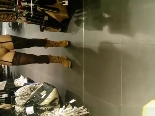 Exhibitionist woman lifts dress in store