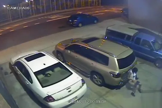 Security camera catches a girl peeing behind a car
