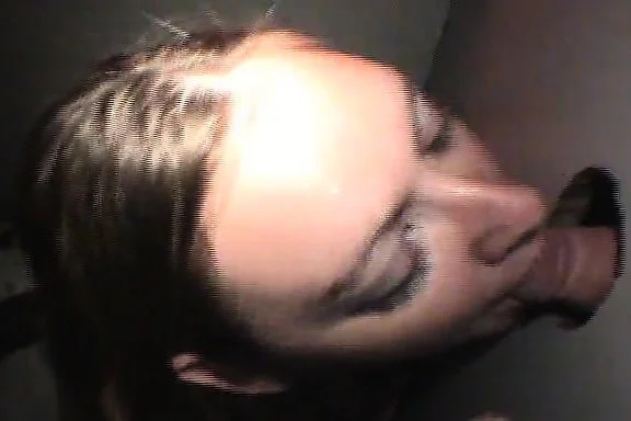 Provocative blonde nympho kneels down and chokes on gloryhole sticks