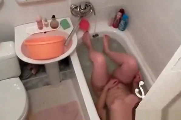 Woman spied in bathtub washing body