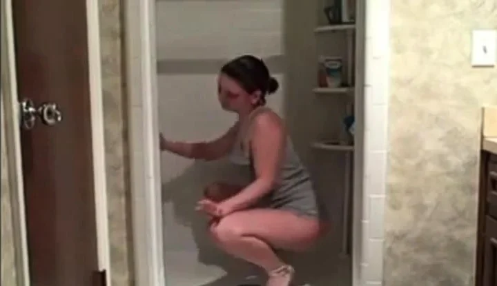 Hot milf cleaning the shower showing her ass