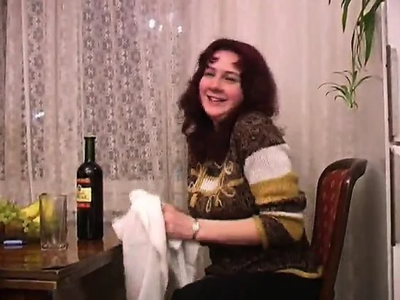 Cute redhead drinks a bottle of wine and then drops all her clothes
