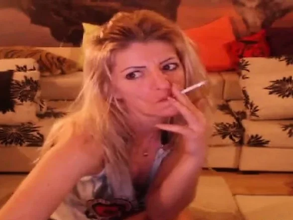 Smoking blonde stripteasing and having fun on webcam