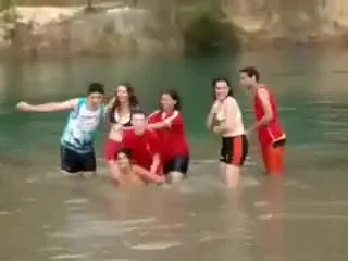 Friends swim in the lake in their underwear