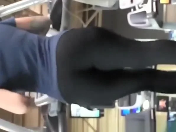 Tattooed woman running in treadmill