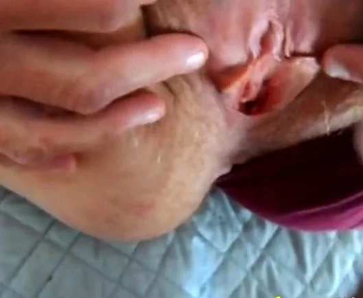 parting her panties to show hairy pussy and hard clit