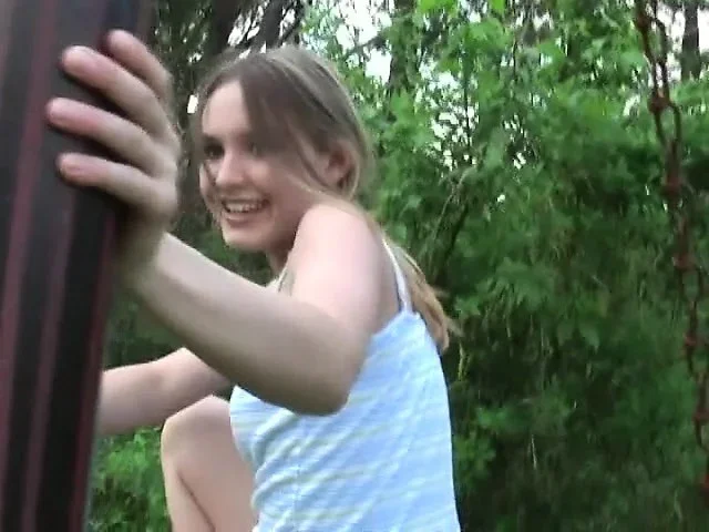 Kitty goes outside to play on the bars and pulls up her blouse and dress