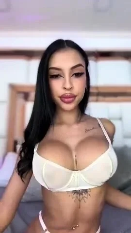 Busty babe playing with her big boobs