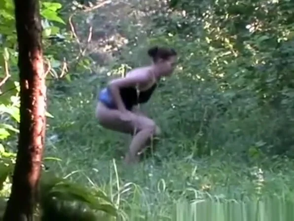 Woman in jeans skirt piss in the nature
