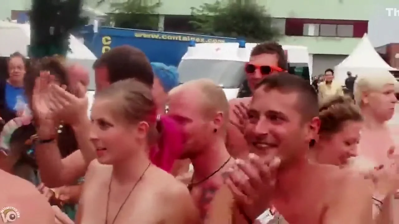 Nudists at the music festival pose for a group picture