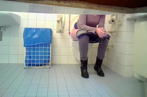 Irresistible babe takes a long piss in the restroom