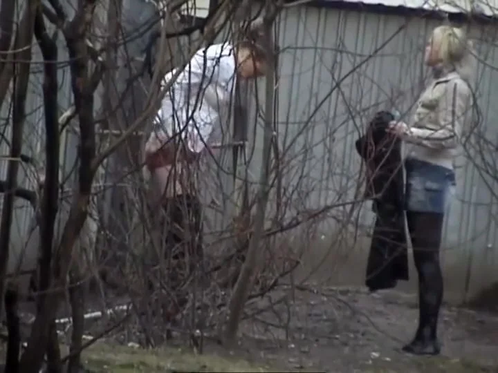 Hot girls piss behind an abandoned house