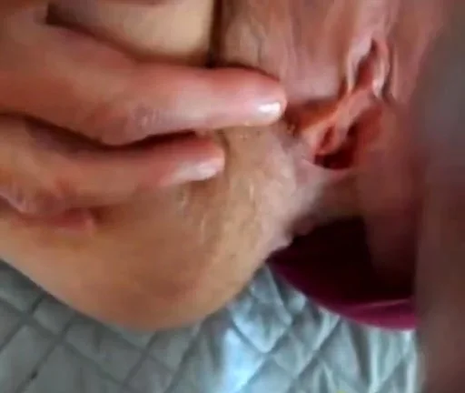 parting her panties to show hairy pussy and hard clit