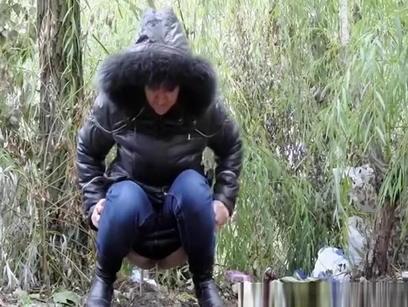 Woman peeing in the nature