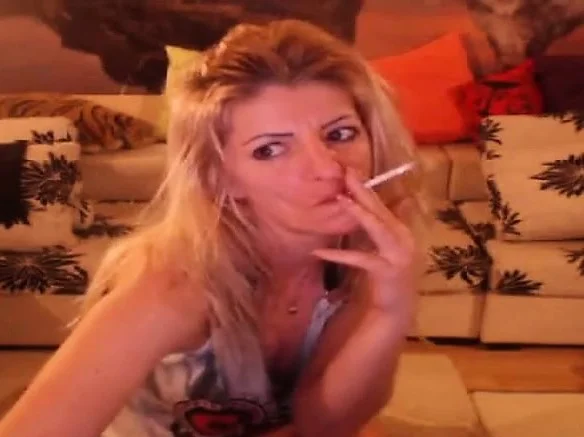 Smoking blonde stripteasing and having fun on webcam
