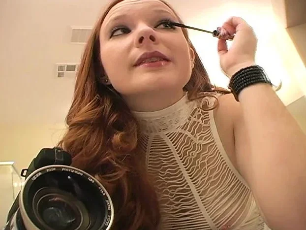 Lovely redheaded girl spreads her legs to let in a massive dildo