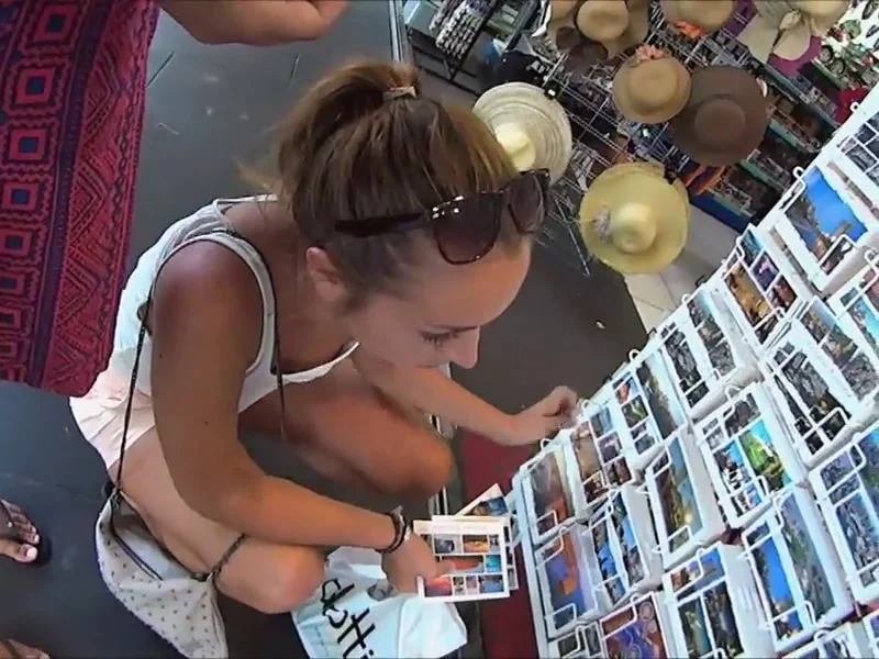 Watch her tits while she buys postcards