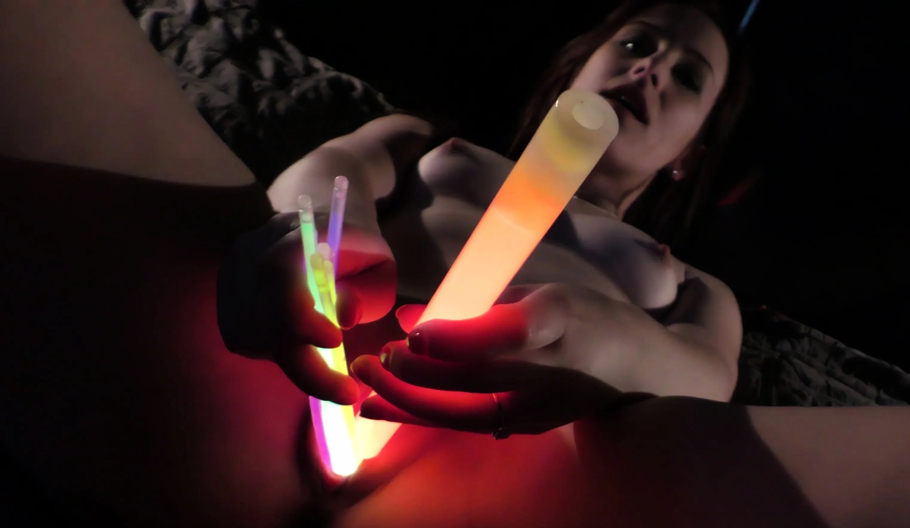 opening up her gash with glow sticks