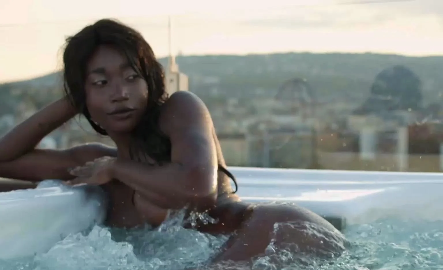 Petite Ebony MILF strips naked in a pool