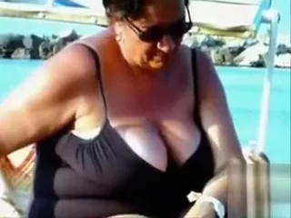 Large saggy breasts in bikini tops by the pool
