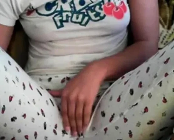 Amateur girl rubs her pussy through pajamas
