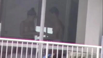 topless girl applying sunscreen thru windown in PR