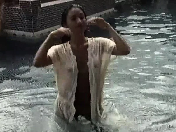 Horny Satomi gets wet and teases the camera while in the pool