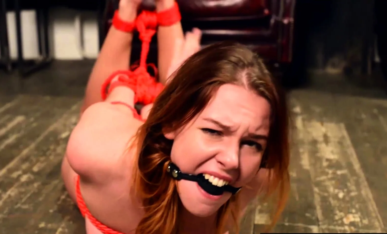 Naked Candy Red tied up within ropes and soles writing