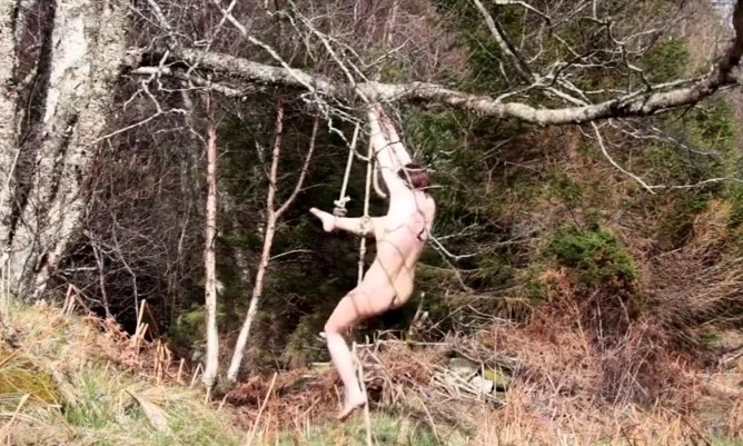 Naked self-bondage in the woods gone wrong.