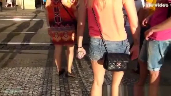 Girl in denim shorts waiting for crossing road