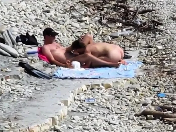 Couple fucked on a public beach while as people walked near