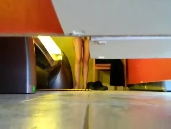 Woman undressing in tanning room