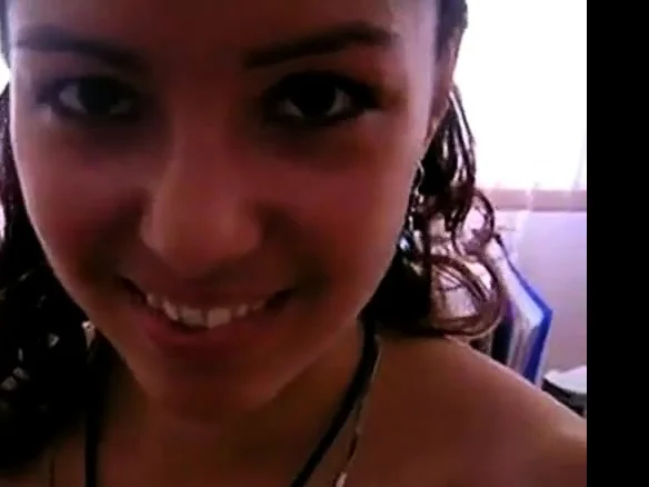 Shy amateur girl with a beautiful smile blows in the office
