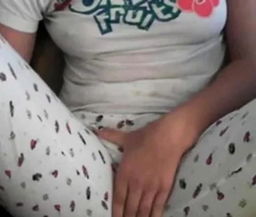 Amateur girl rubs her pussy through pajamas