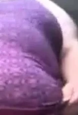 SSBBW in a purple dress plays with her giant belly