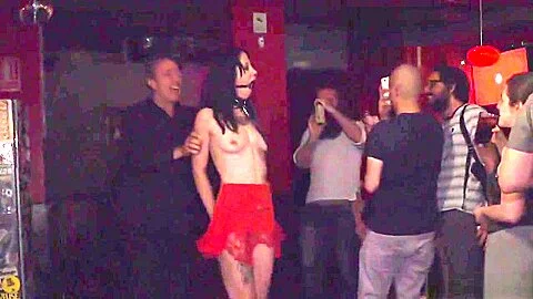 Gagged brunette tormented in public bar