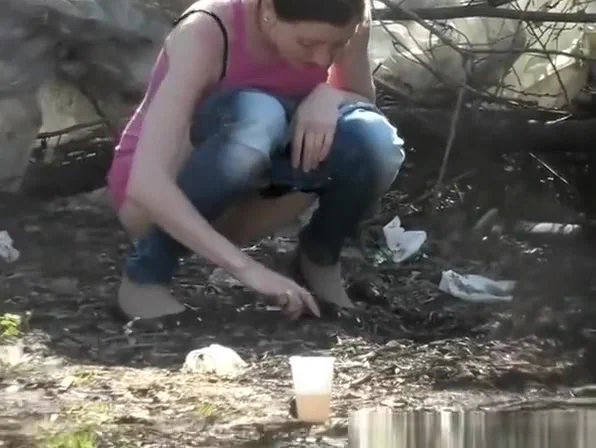 Chick in tight jeans pulls them down to take a piss