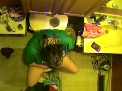 Taking a pee and looking at her own pussy