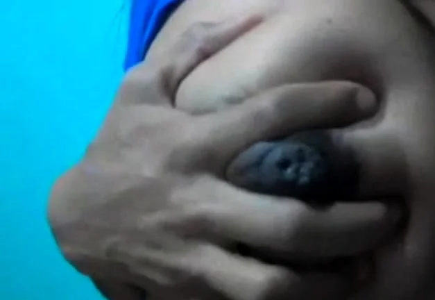 Squeezes out milk from her dark nip ttis