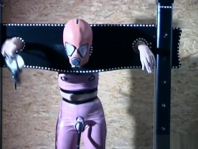 Gimp girl locked in box and pillory