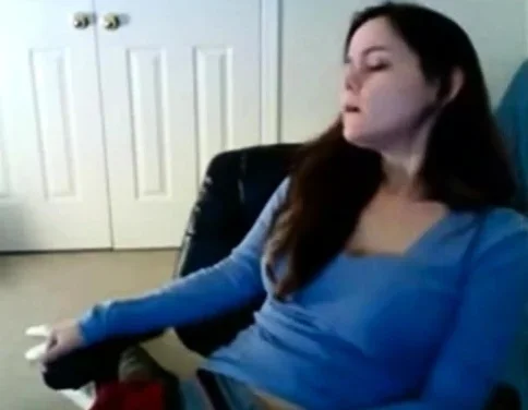 Babe has her hand down her sweat pants masturbating on cam