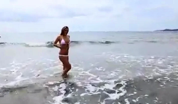 Dionne Daniels strips on the beach