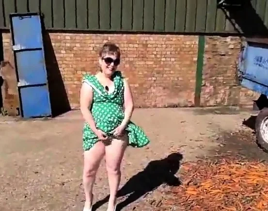 Flashing in green dress and white stilettos