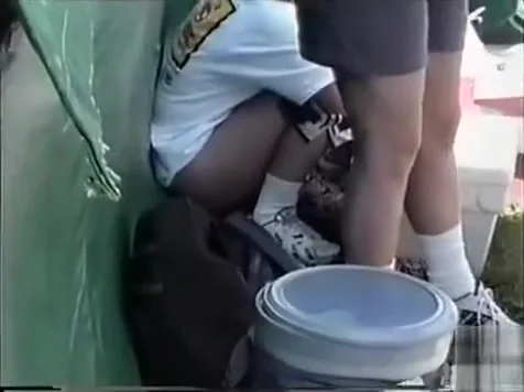 Desperate chicks relieve themselves outdoors at a summer festival