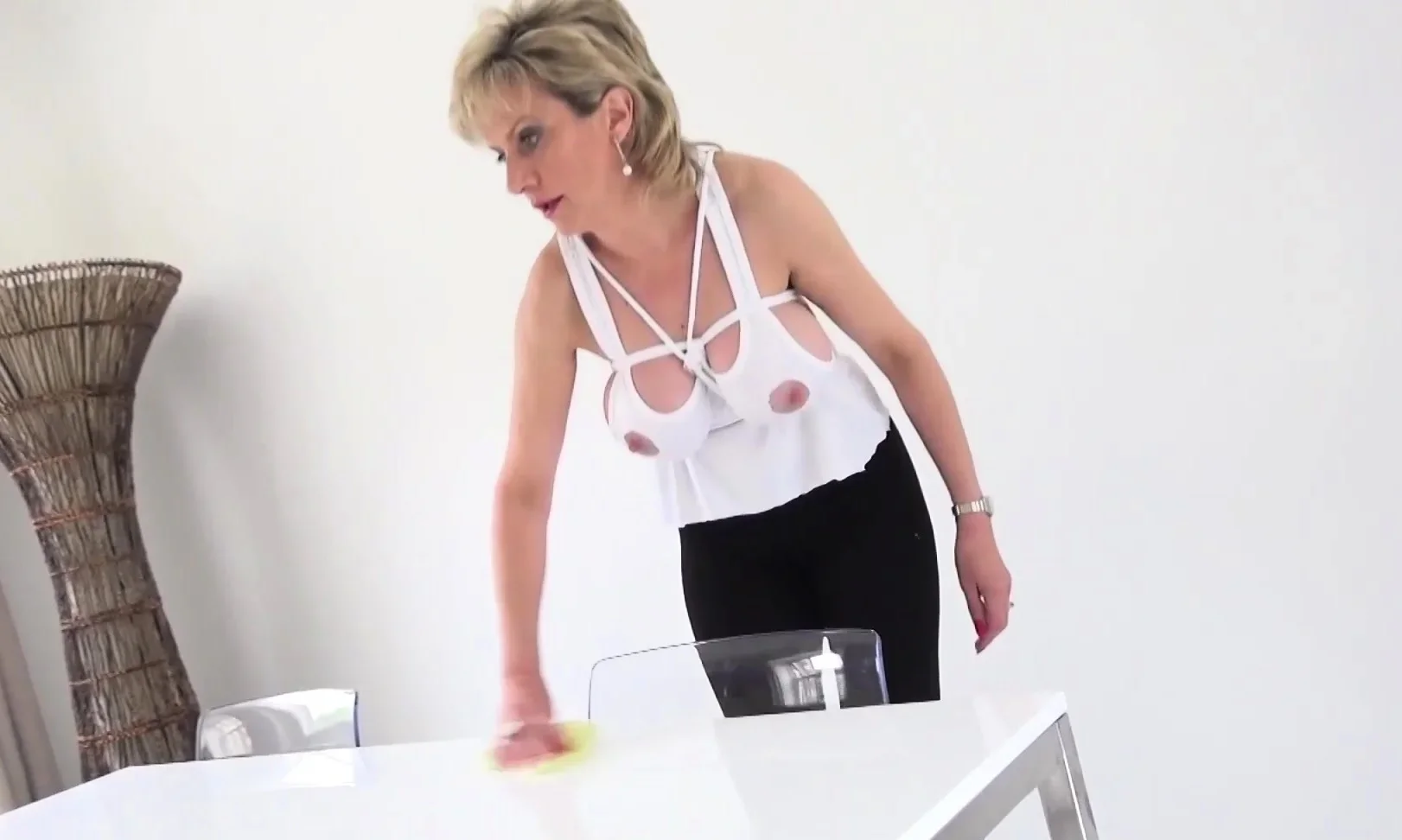 Lady Sonia has her tits bound while cleaning the house
