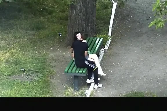 teen 18+ couple making out in public park bench