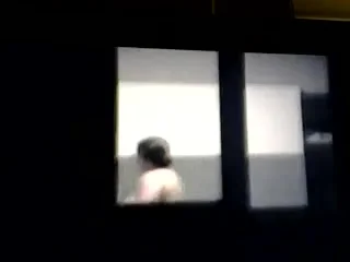woman spied topless through window